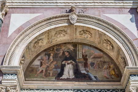 Exterior fresco with priest, Jesus and the angels in arch of Basilica of Santa Maria Novella,...