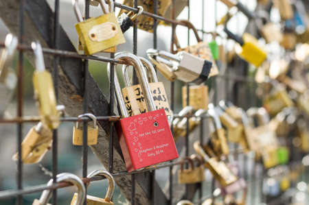 PARIS - SEPT 17, 2014: Love padlocks on the bridge Pont des Arts across river Seine in Paris, France.のeditorial素材