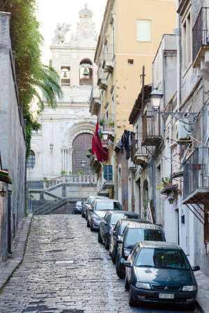 Catania, Italy - September 13, 2015: Street view in center of Catania, Sicily, Italy. Church on the background.のeditorial素材