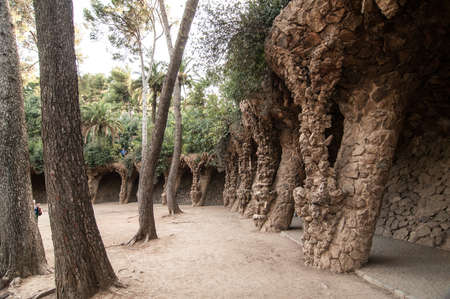 Barcelona, Spain - September 20, 2014: Colonnaded pathway. Road projects out from the hillside and forming a wall which curves over to support the road, and transmits the load onto sloping columns.のeditorial素材