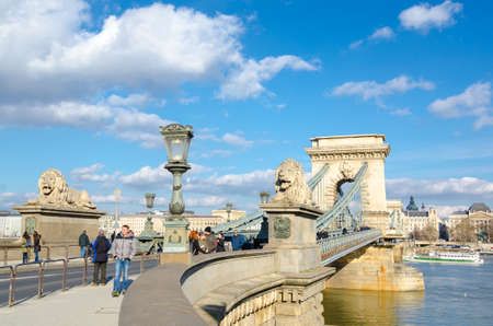 BUDAPEST, HUNGARY - FEBRUARY 20, 2016: The Szechenyi Chain Bridge is a suspension bridge that spans the River Danube between Buda and Pest. The Guardian lions at each of the abutments carved in stone.のeditorial素材