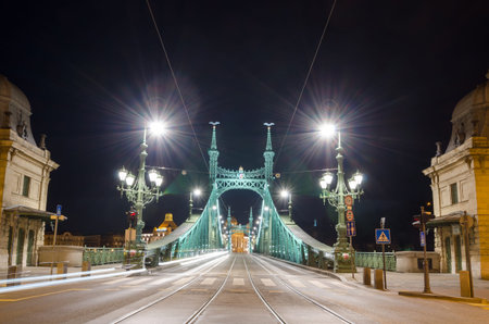 BUDAPEST, HUNGARY - FEBRUARY 22, 2016: Night view of Liberty Bridge - Freedom Bridge in Budapest, Hungary, connects Buda and Pest across the River Danube.のeditorial素材