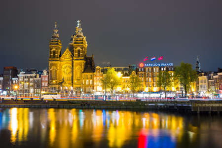 Amsterdam, Netherlands - April 20, 2017: Beautiful night in Amsterdam. Night illumination of buildings and boats near the water in the canal.のeditorial素材