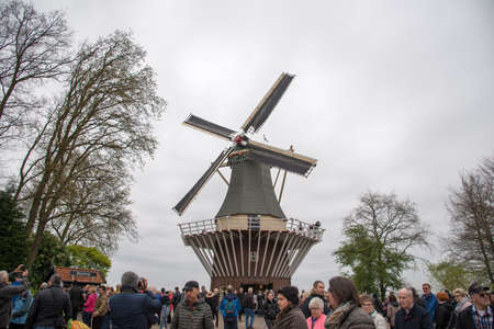 Keukenhof, Netherlands - April 21, 2017: Old windmill with many people in famous garden in Keukenhof.のeditorial素材