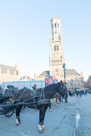 Bruges, Belgium - April 17, 2017: Horse carriage on Grote Markt square in Belgian city of Bruges.のeditorial素材
