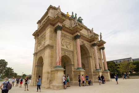 PARIS - SEPT 17, 2014: Tourists near the Arc de Triomphe du Carrousel. It is a triumphal arch in...
