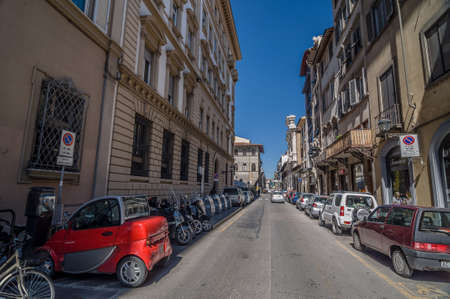 FLORENCE, ITALY - APRIL 14, 2013: Small red electric car on street Borgo Ognissanti in Florence, Toscany, Italy.のeditorial素材