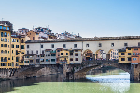 FLORENCE, ITALY - APRIL 14, 2013: The Ponte Vecchio (Old Bridge) is a Medieval stone closed-spandrel segmental arch bridge over the Arno River. Florence, Tuscany, Italy.のeditorial素材