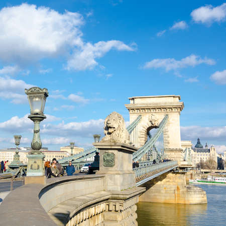 BUDAPEST, HUNGARY - FEBRUARY 20, 2016: The Szechenyi Chain Bridge is a suspension bridge that spans the River Danube between Buda and Pest. The Guardian lions at each of the abutments carved in stone.のeditorial素材