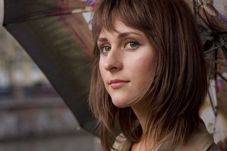 Portrait of a young beautiful woman with umbrellaの写真素材