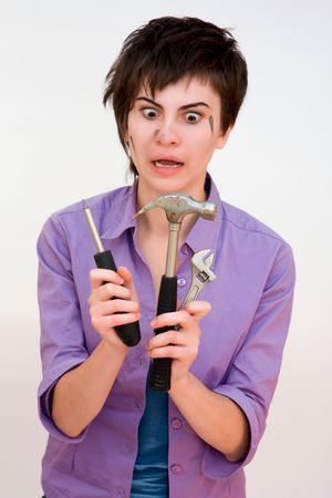 Portrait of a young beautiful woman holding toolsの写真素材