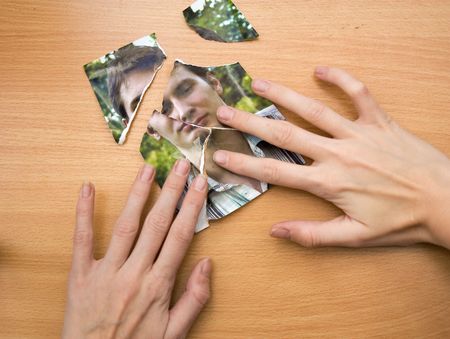 woman trying to glue togerther picture piecesの写真素材