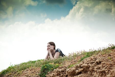 young woman lying on grassの写真素材