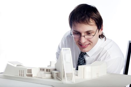 young architect looking at architectural modelの写真素材
