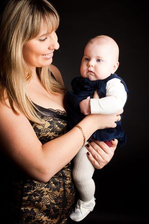 beautiful other with cute baby daughter over whiteの写真素材
