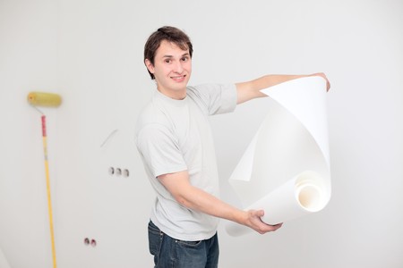 young happy man making renovation of his apartmentの写真素材