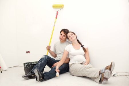 young couple waiting baby resting after renovation of their apartmentの写真素材
