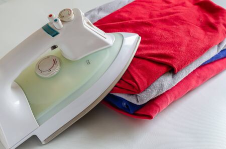 Plug-in iron for shirts. Fire hazard. Home insurance. Selective focus.の写真素材