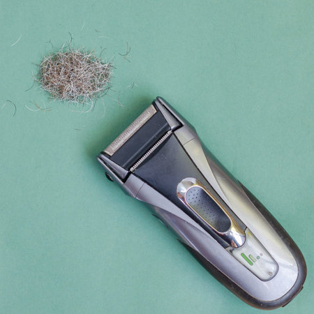 Top view of a Electric shaver and a bunch of shaved hair. Everyday hygiene and shaving. Close-up....