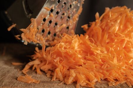 Closeup of a bunch of fresh uncooked root vegetables. Eye level shooting. Selective focus. Cooking process.の写真素材