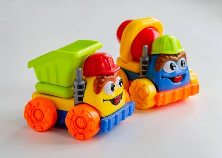 Two bright toy cars. Toys for preschool children. Selective focus. Close-up.の写真素材