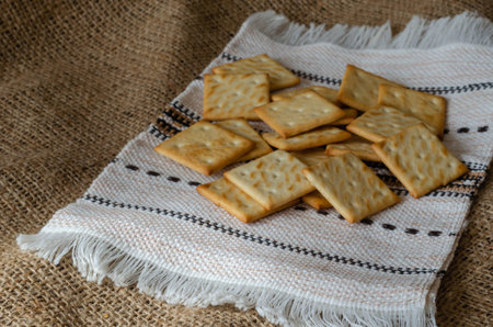 Salted crackers on a linen towel. Homemade treats cool after cooking. Traditional treats. Eye level...
