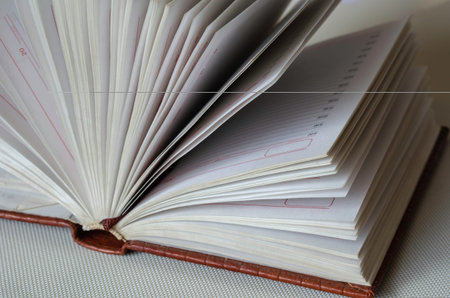 Side view of blank pages. Brown leather binding of a businessman's diary. Close-up. Selective focus.
