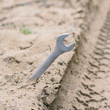 Hand tools on a dirt road. Damage and help on the way. Close-up. Selective focus. Without people.