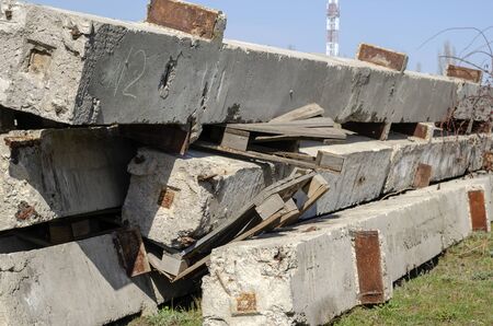 Used concrete piles outdoors. A group of old reinforced concrete products stacked on top of each other. Reuse of building materials. Selective focus. Without people.の写真素材