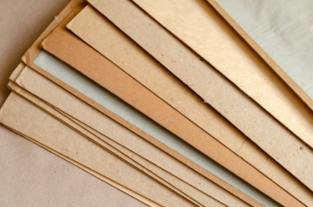 Thick sheets of brown cardboard. A stack of rectangular sheets of recycled paper. Abstract...