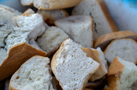 Dry slices of wheat bread with mold. Large pieces of spoiled bread. Close-up. Selective focus. Side...
