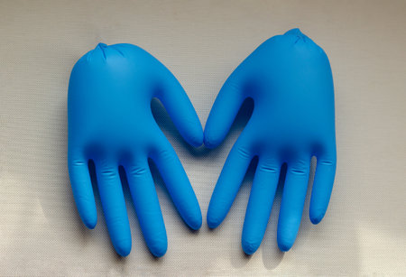 Inflated medical gloves on the table. A pair of blue gloves shows a symbol of love. Ambiguous...
