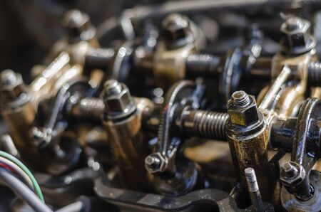 Disassembled four-stroke gasoline engine. Detailed shot of carburetor engine without valve cover. Retro car repair. Side view. Selective focus. Close-up.の写真素材