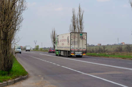 Nikolaev, Ukraine April 10, 2020: suburban traffic. The truck tractor rides on an unloaded asphalt road. Shooting from the sidelines. Selective focus.のeditorial素材