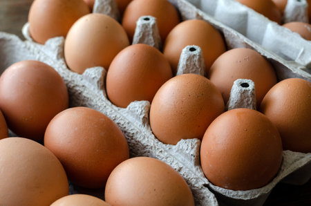 Brown chicken eggs in the trays. Trays of raw farm eggs. Traditional food. View from above....