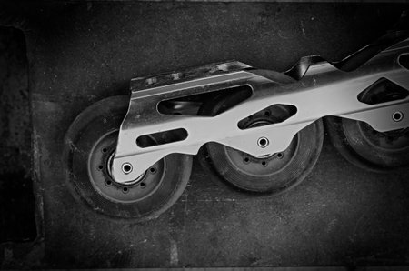Aggressive inline skates disassembled. Professional roller blades on the floor. Hard alloy roller...