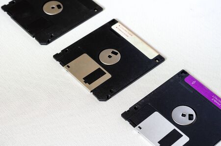 3.5 inch magnetic floppy disks. Three floppy disks with a capacity of 1.44 MB. Obsolete digital data storage media. Close-up. Selective focus.の写真素材