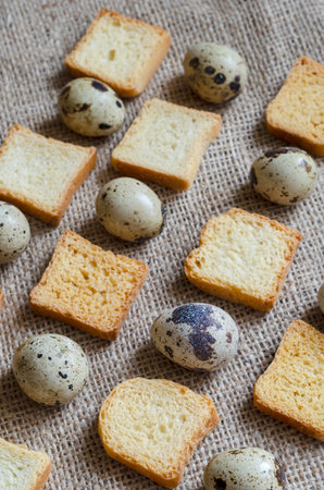 Pattern of instant quail eggs and croutons. Fresh eggs and crispy croutons in a repetitive ornament...