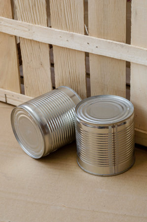 Canned food in cans. Two metal shut jars of ready-to-eat food. Long-term food products. Top view at...