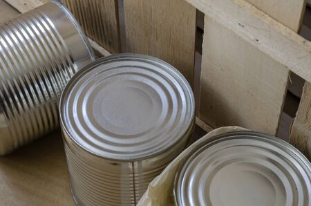 Canned food in cans. Three metal shut jars of ready-to-eat food. Long-term food products. Top view at an angle. Selective focus.の写真素材