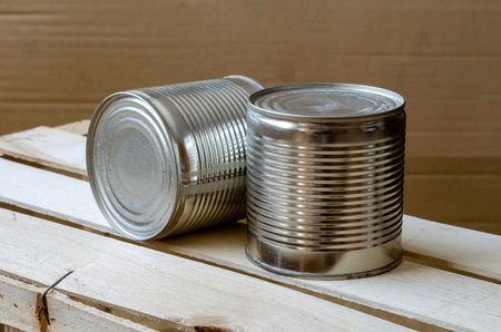 Canned food in cans. Two metal shut jars of ready-to-eat food. Long-term food products. Top view at...