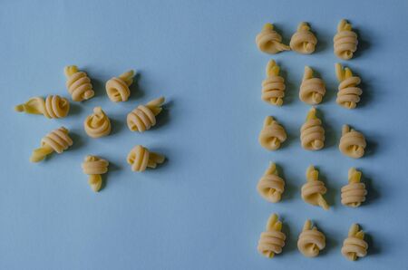 Creative background with insalatonde pasta on a light blue background. Geometric shapes and lines from the Ingredients of Traditional Mediterranean Cuisine. Gastronomy. Copy space.の写真素材