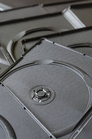 Empty black box dvd background. A pile of open plastic boxes for cd, dvd and blu-ray discs. Full frame. View from above. Abstract background.の写真素材
