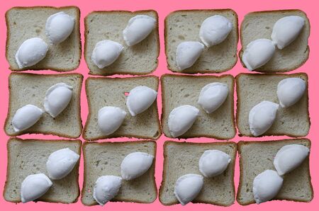 Creative background with frozen dumplings and bread for toasts. Raw dumplings with hoarfrost lie on top on pieces of bread. Dumplings with meat are located diagonally. Full frame. View from above.の写真素材