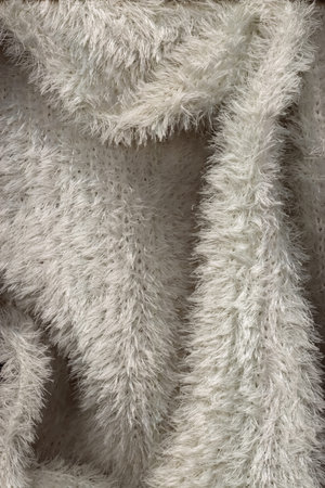 White fleecy fabric texture. A detailed snapshot of a fragment of a soft touch of fabric. Textile...