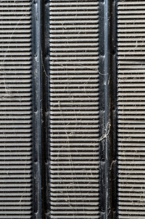 Abstract geometric background with dirt and dust. Perforated black sheet of metal covered with a...