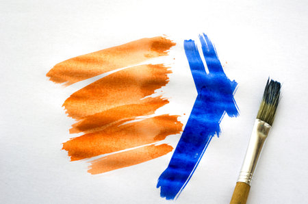 Art brush and strokes of watercolor paint on white paper. Drawing lessons. Training, hobbies,...