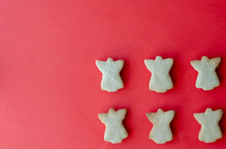 Delicious homemade Christmas cookies on a red background. Traditional holiday baked goods. Top view at an angle.の写真素材