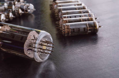 Random vacuum tubes on a black background. A group of radio tubes of different sizes and purposes. Shooting at eye level. Selective focus.の写真素材