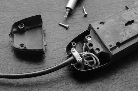 Electric splitter, cable and screwdriver. Connecting wiring to the contacts of the electrical splitter. Top view at an angle. Selective focus.の写真素材